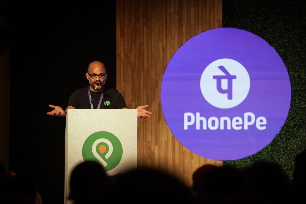 Sameer Nigam at podium with PhonePe logo shown