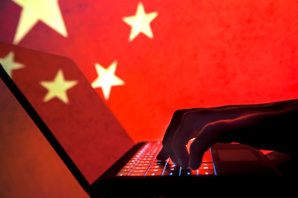 Cybercriminal, hacker China flag background.