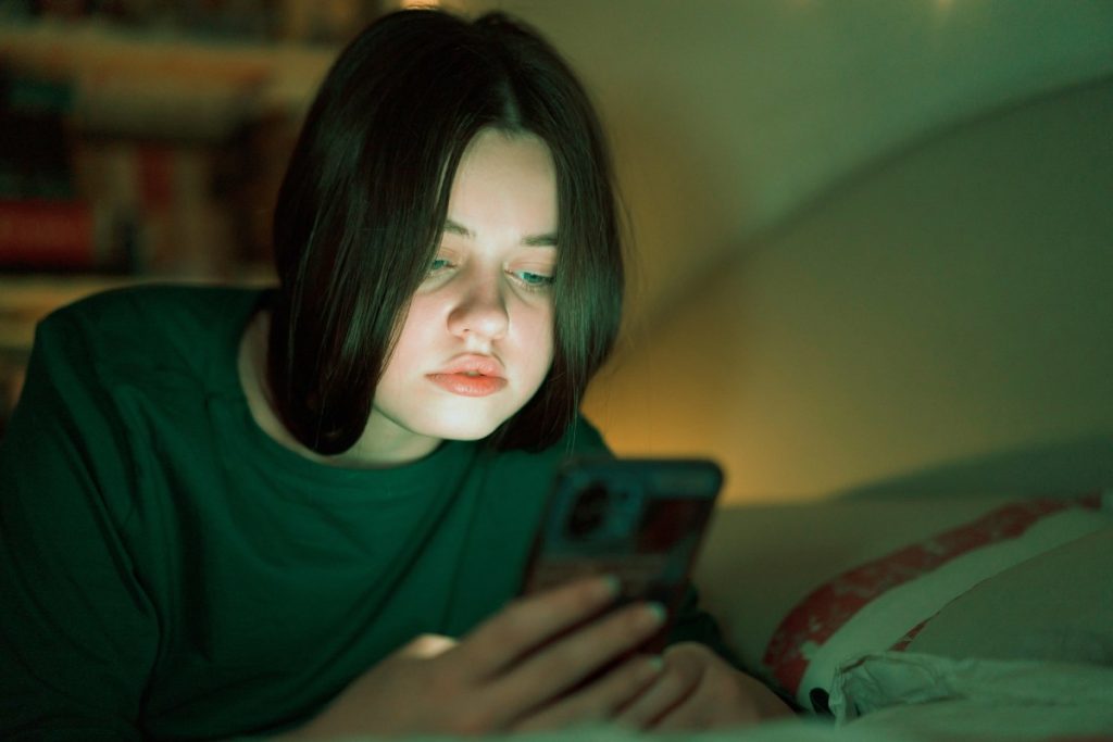 Portrait of a teenage girl looking at her mobile phone.