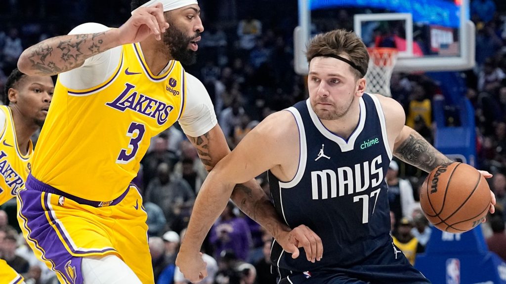 Dallas Mavericks guard Luka Doncic drives against Los Angeles Lakers forward Anthony Davis (3) during the first half of an NBA basketball game in Dallas, Tuesday, Dec. 12, 2023. (AP Photo/LM Otero)