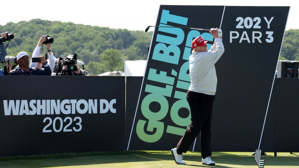 Donald Trump plays a tee shot during the pro-am prior to the LIV Golf Invitational - DC at Trump National Golf Club