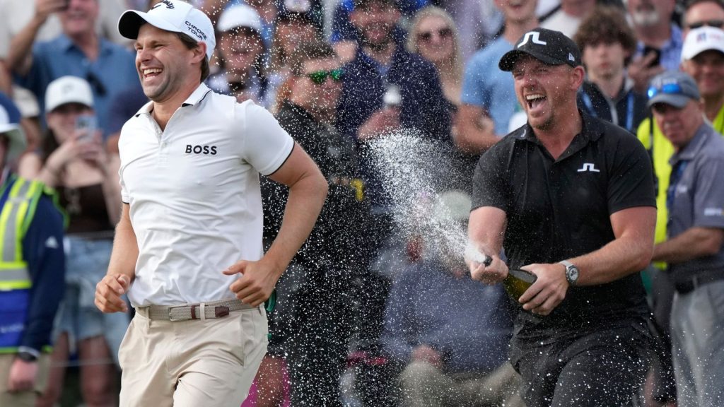 Thomas Detry, left, of Belgium, smiles as he celebrates his win at the Phoenix Open golf tournament at TPC Scottsdale with fellow golfer Matt Wallace