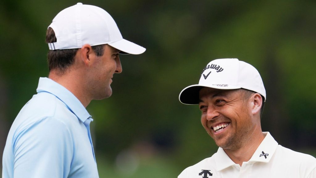 Scottie Scheffler and Xander Schauffele smile on the fifth hole during a practice round for the PGA Championship golf tournament at the Quail Hollow Club, Tuesday, May 13, 2025, in Charlotte, N.C. (AP Photo/George Walker IV)